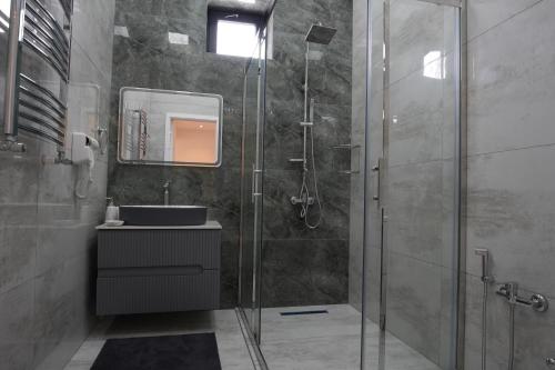 a bathroom with a shower and a sink at White Harmony Houses in Şamaxı