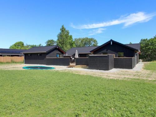 a house with a pool in front of a yard at Holiday Home Tahvo - 3-3km from the sea by Interhome in Rømø Kirkeby