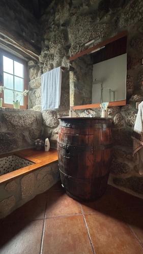 a large wooden barrel sitting in a room with a counter at Casa das Andorinhas in Celorico de Basto