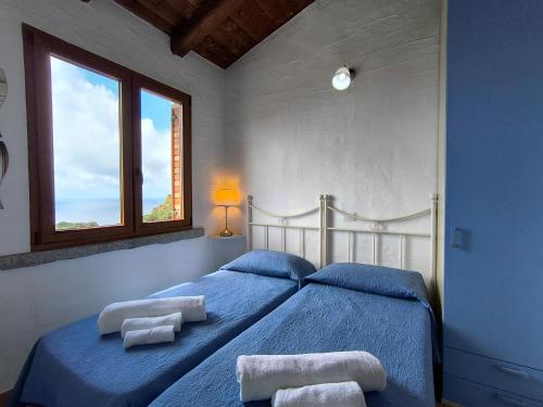 a bedroom with two beds with towels on them at Villa Laura in Nebida