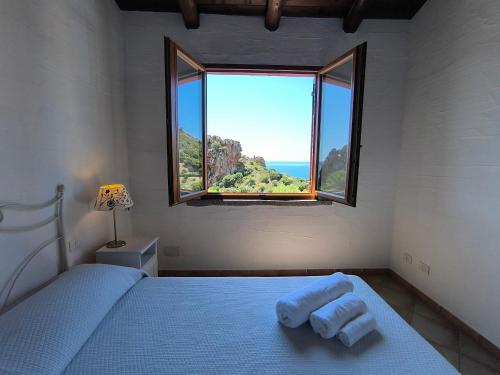 a bedroom with a bed with a large window at Villa Laura in Nebida