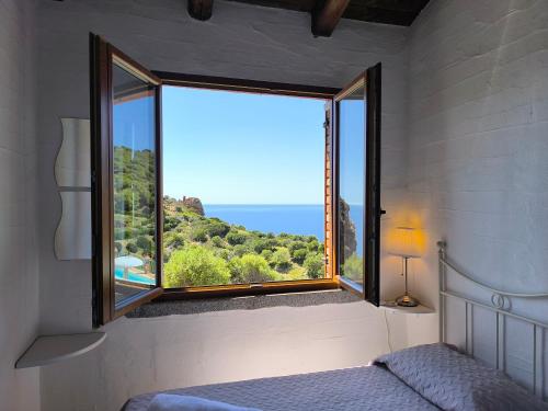 a bedroom with a window with a view of the ocean at Villa Laura in Nebida