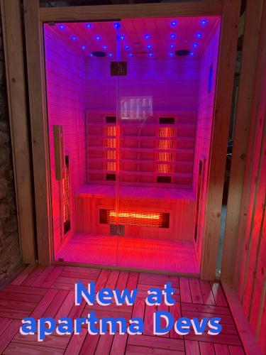 a neon sign that says new at aquarium digs at Apartma Devs in Kranjska Gora
