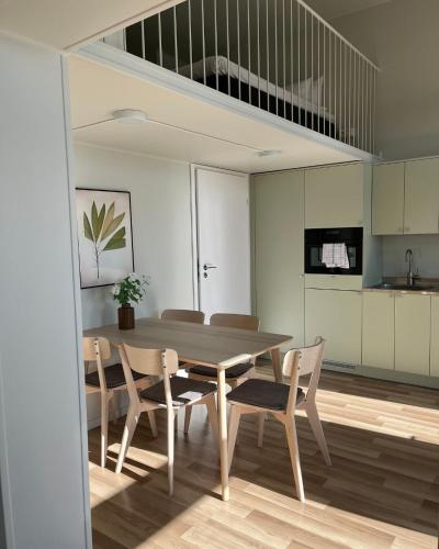 a kitchen and dining room with a table and chairs at Waterfront Cabins in Gothenburg