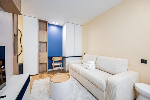 - un salon avec un canapé et un tabouret dans l'établissement CozyStudioParis-Montmartre-Opera, à Paris