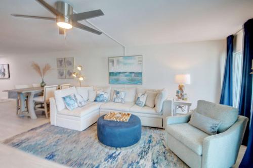 a living room with a couch and a table at El Matador 344 - Beautiful views of the Gulf and pool in Fort Walton Beach
