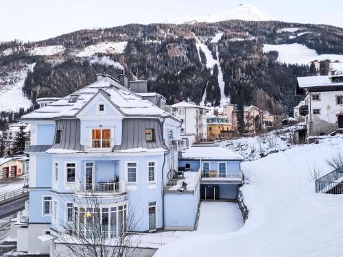 a house in the snow with mountains in the background at Apartment Villa Hiss by Interhome in Bad Gastein