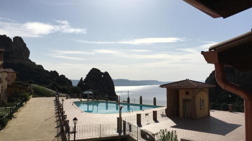 a swimming pool with a view of the water at Villa Laura in Nebida