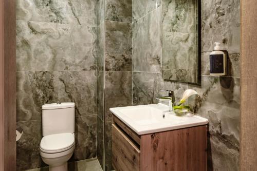 a bathroom with a toilet and a sink at Spinola Hotel in St Julian's