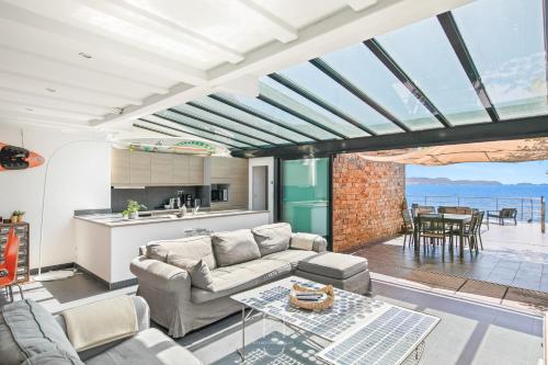 ein Wohnzimmer mit Sofa und Tisch in der Unterkunft Maison sur l'eau-Hyères-Almanarre-Parkings Clim WIFI By HC in Hyères