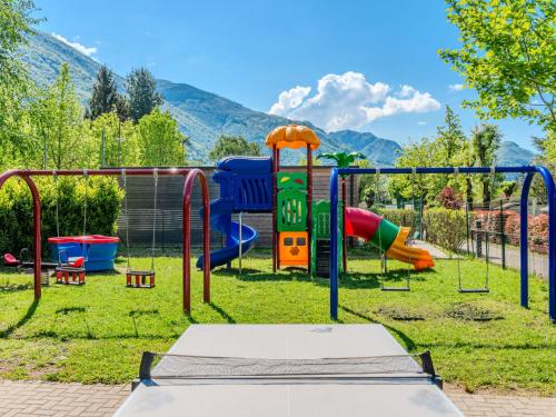 a park with a playground with a slide at Apartment Camping Turisport-4 by Interhome in Dervio