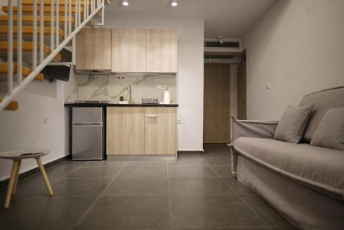 a living room with a couch and a kitchen at Azur Infini suites and apartments in Olympiada