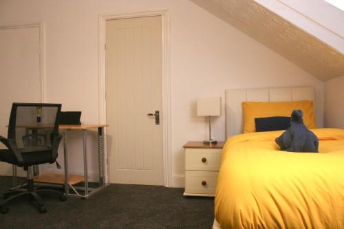 a cat sitting on a bed in a bedroom at Coastal Comfort in Hartlepool