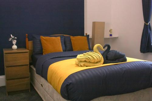 a bedroom with a bed with a swan on it at Coastal Comfort in Hartlepool