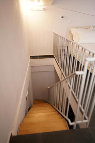 a staircase leading up to a room with a bed at Azur Infini suites and apartments in Olympiada