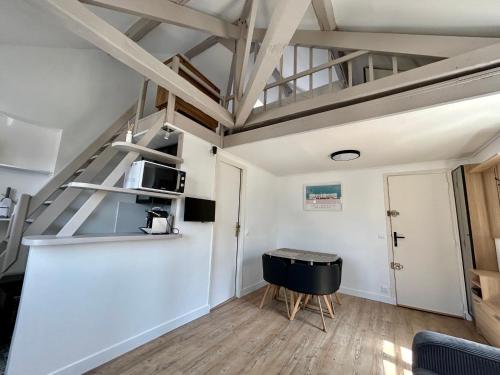 a small room with a table and a microwave at Les toits de Deauville in Deauville