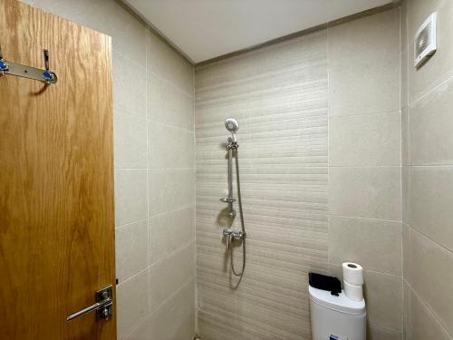 a bathroom with a shower and a toilet in it at Charming Bright Flat in Historic La Ville Haut in Kenitra