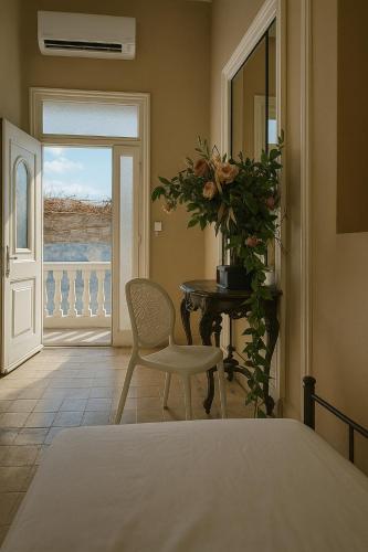 a bedroom with a bed and a table and a chair at Villa ZeN- with Private garden and beach in Samos