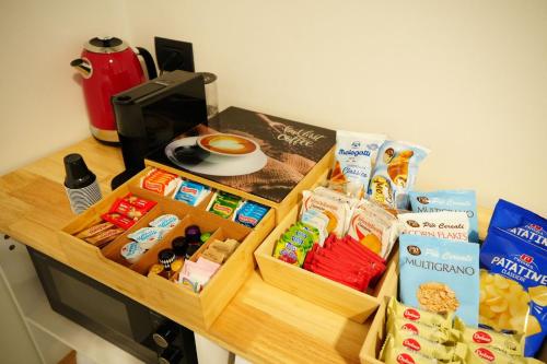 a table with several boxes of food on it at The One Malpensa Rooms in Vizzola Ticino