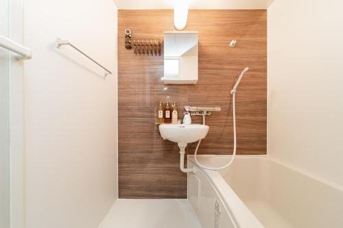 a bathroom with a sink and a toilet and a tub at aiki house in Tokyo