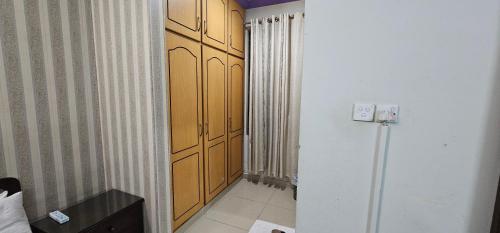 a hallway with wooden cabinets in a room at The Host Lodge in Islamabad