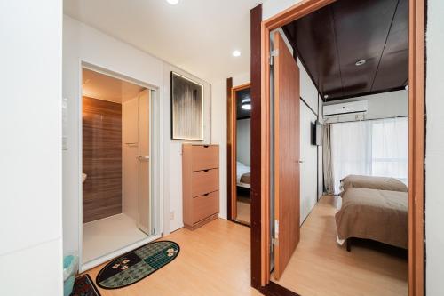 a small bedroom with a bed and a mirror at aiki house in Tokyo