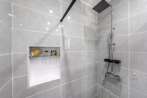 a bathroom with a shower with a glass door at Donna's luxury home in Kassiopi 300m from the sea in Kassiopi