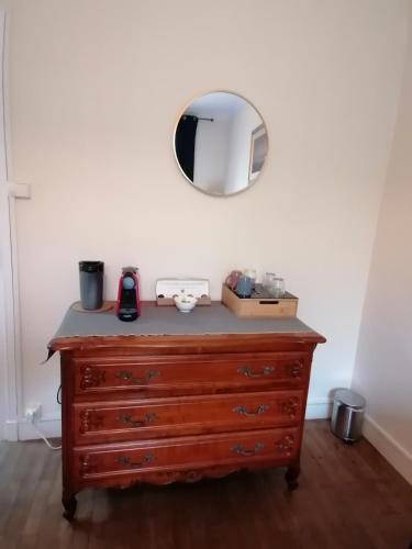 a dresser with a mirror on top of it at Trecastle in Châlus