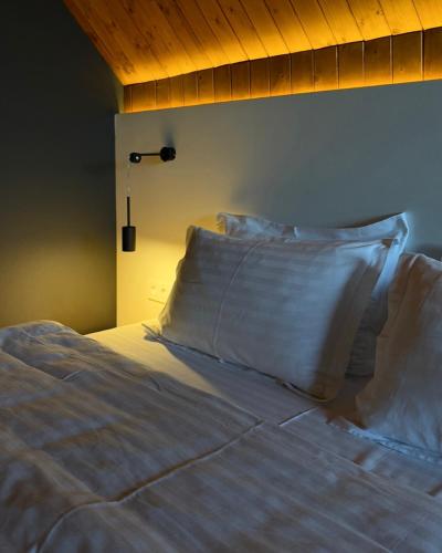 a bed with two pillows sitting on top of it at Krasnyk Resort in Krasnik