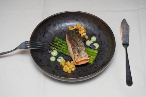 a plate of food with a steak and vegetables at Parkhotel Flora am Schluchsee in Schluchsee