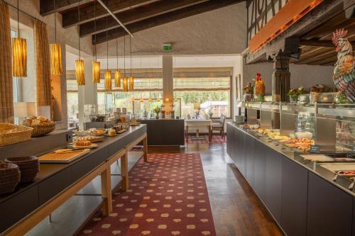 a restaurant with a buffet line with food on display at Parkhotel Flora am Schluchsee in Schluchsee