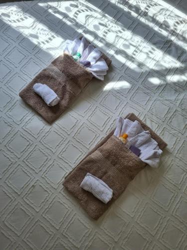 three towels are sitting on a tile floor at IL Posticino DI Bellagio in Civenna