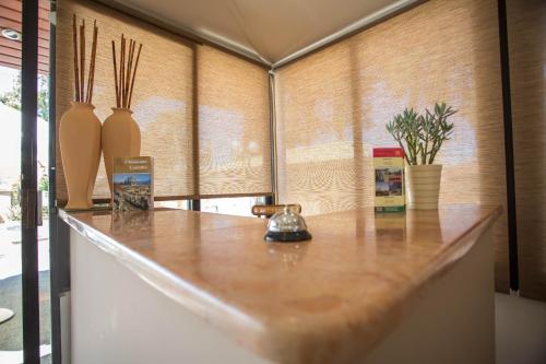a kitchen counter with three vases on top of it at Vasilios Marinos Rooms in Korinthos