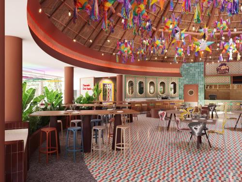 a restaurant with tables and chairs and a chandelier at Bahia Principe Grand Tequila - Adults Only All Inclusive - New Opening Dec 2025 in Akumal