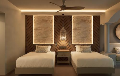 a bedroom with two beds and a ceiling fan at Bahia Principe Grand Tequila - Adults Only All Inclusive - New Opening Dec 2025 in Akumal