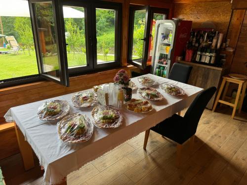 a table with several plates of food on it at Maxper house in Krapinske Toplice