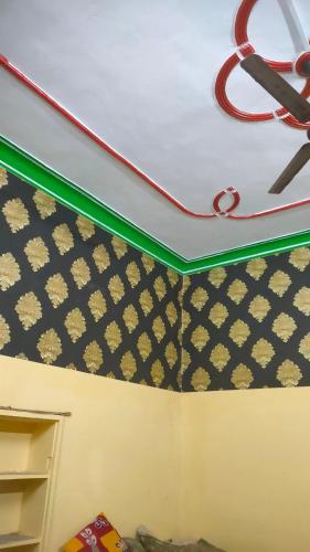 a room with a bed with a shelf and a ceiling at Krishna plaza in Sālpura