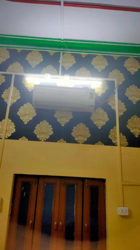 a chandelier hanging above a door in a room at Krishna plaza in Sālpura