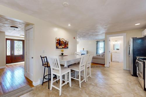 a kitchen and dining room with a table and chairs at Buttermilk Bliss in Wareham