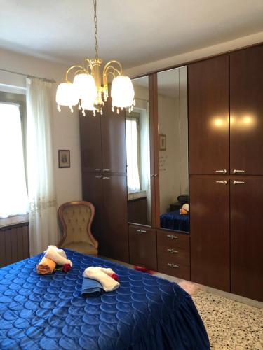 a bedroom with a blue bed and a large mirror at La Primula Vicinanza 5 Terre in Riccò del Golfo di Spezia