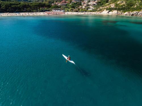 a person on a kayak in the middle of the water at Hotel Galli - Wellness & Spa in Fetovaia
