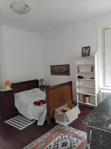 a bedroom with a bed and a dresser at La Tour Des Douves in La Celle-sous-Gouzon