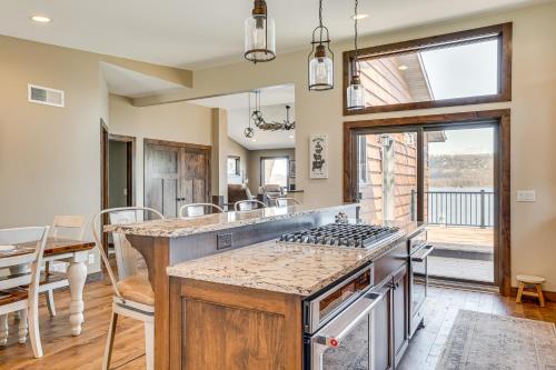 a kitchen with an island with a stove top oven at Riverfront Home with Yard Games in Wabasha! in Wabasha