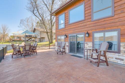 a patio with chairs and a table on a house at Riverfront Home with Yard Games in Wabasha! in Wabasha
