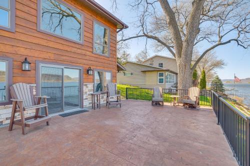 a patio with chairs and a table in front of a house at Riverfront Home with Yard Games in Wabasha! in Wabasha