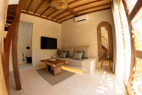 a living room with a couch and a table at Divino Gili Air in Gili Air