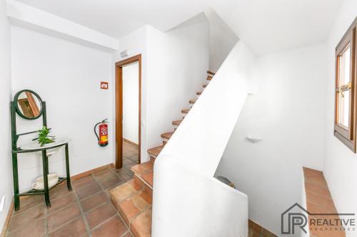 a staircase in a house with white walls at La Casa de la Iglesia in Mijas