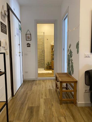 a hallway with a table and a glass door at ZEFIRO OSTIA-Free parking & Terrace in Lido di Ostia
