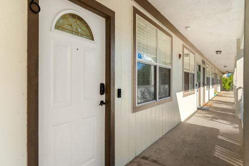 a white door with a window on a building at Convenient & Inviting - Fully-Equipped 2BD Condo in Gainesville