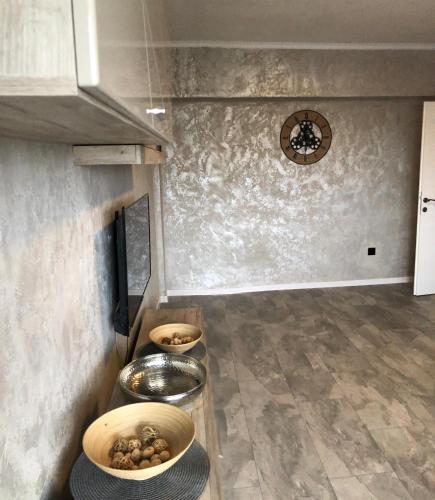 a kitchen with bowls of food on a counter at Alfredo Apartament in Buzău